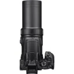 Top view of a professional digital camera with extended zoom lens.