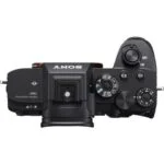 Top view of a Sony mirrorless camera body with control dials and buttons.