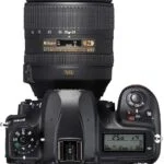 Nikon D780 DSLR with 24-120mm lens, top view showing controls and display.