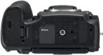 Bottom view of Nikon D850 camera body, showcasing tripod mount and battery compartment.