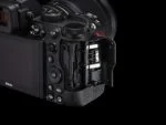 Nikon Z5 camera body with open memory card slot, showcasing photography equipment features.