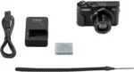 Canon PowerShot G7 X Mark II with accessories including charger, battery, and strap.