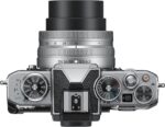 Top view of Nikon Z fc camera with 16-50mm lens, showcasing dials and controls.
