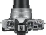 Top view of Nikon Z fc camera with 16-50mm lens, showcasing dials and controls.