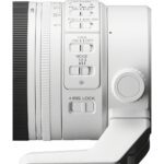 Side view of a white camera lens with control switches, ideal for professional photography.