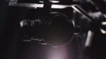 Close-up of a professional camera on a gimbal in a studio setting.