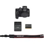Canon EOS R7 camera body with battery, charger, and strap.