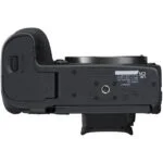 Bottom view of Canon R7 camera body, showcasing battery compartment and mount.