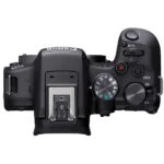 Top view of Canon R10 camera body with control dials and hot shoe.