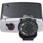 Vintage-style camera light meter with dials and leather texture, ideal for photography enthusiasts.