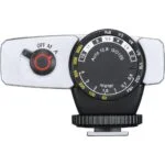 Vintage camera light meter with dials and settings, photography equipment.