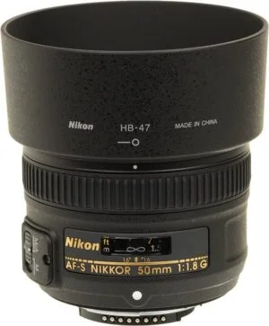 Nikon AF-S NIKKOR 50mm f/1.8G lens with hood, ideal for DSLR cameras.