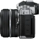 Nikon Z fc mirrorless camera with 28mm lens, side view, available at UK camera shop.