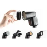 Photography flashgun with interchangeable diffusers and accessories.