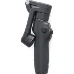 Compact black camera gimbal for stabilizing video footage, ideal for professional photography and videography.