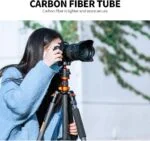 Photographer using a Sony camera on a carbon fiber tripod outdoors.