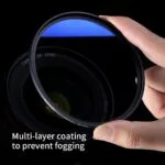 Camera lens filter with multi-layer coating held in hand.