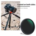 Camera on tripod with lens filter, beach background, coated for reflection reduction.