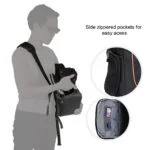 Person using a camera bag with side zippered pockets for easy access.