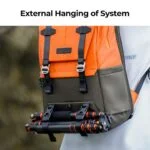 Orange and gray camera backpack with tripod attached, ideal for photographers.