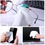Cleaning glasses, phone, and laptop with a microfiber cloth.