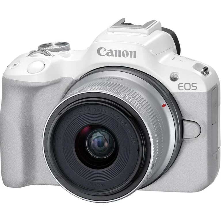 White Canon EOS mirrorless camera with lens, available at Camix UK.