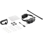 DJI drone goggles and accessories including lenses and cleaning cloth on white background.