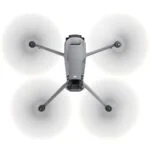 Top view of a DJI drone with spinning propellers, available at Camix camera shop UK.