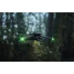 DJI drone flying in a forest, showcasing advanced photography equipment.