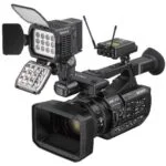 Professional Sony video camera with lighting and wireless audio equipment.