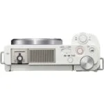 Top view of a compact mirrorless camera with control dials and buttons.
