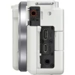 Side view of a white digital camera showing HDMI and USB ports, ideal for photography enthusiasts.