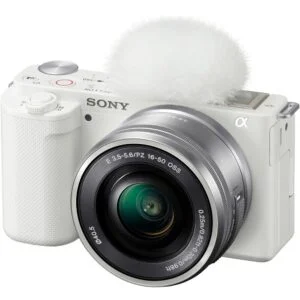 White Sony mirrorless camera with lens and microphone, ideal for photography and video.