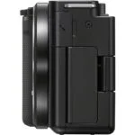 Side view of a black digital camera body with textured grip.