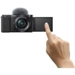 Sony mirrorless camera with flip screen and microphone, ideal for vlogging.