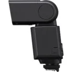 Side view of a black camera flashgun for photography lighting.
