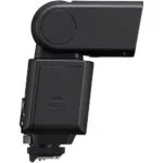 Side view of a black camera flashgun for photography lighting.
