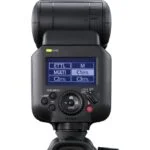 Professional camera flashgun with digital display and control buttons.