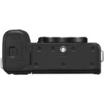 Bottom view of a mirrorless camera body available at Camix, featuring a tripod mount and battery compartment.