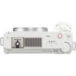 Top view of a white mirrorless camera with control dials and hot shoe, ideal for photography enthusiasts.