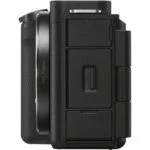 Side view of a black mirrorless camera body with textured grip.