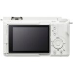 Back view of a white digital camera with LCD screen and control buttons.