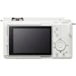 Back view of a white digital camera with LCD screen and control buttons.