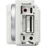 White mirrorless camera body with open ports and card slots, ideal for photography enthusiasts.