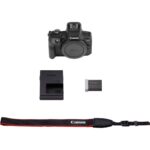 Canon EOS camera body with battery, charger, and strap.