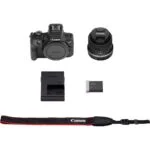 Canon EOS camera kit with lens, battery, charger, and strap.