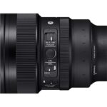 Close-up of a camera lens with focus and lock switches, ideal for professional photography.