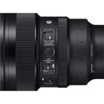 Close-up of a camera lens with focus and lock switches, ideal for professional photography.