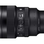 Close-up of a camera lens with focus and lock switches, ideal for professional photography gear.