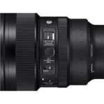 Close-up of a camera lens with focus and lock switches, ideal for professional photography gear.